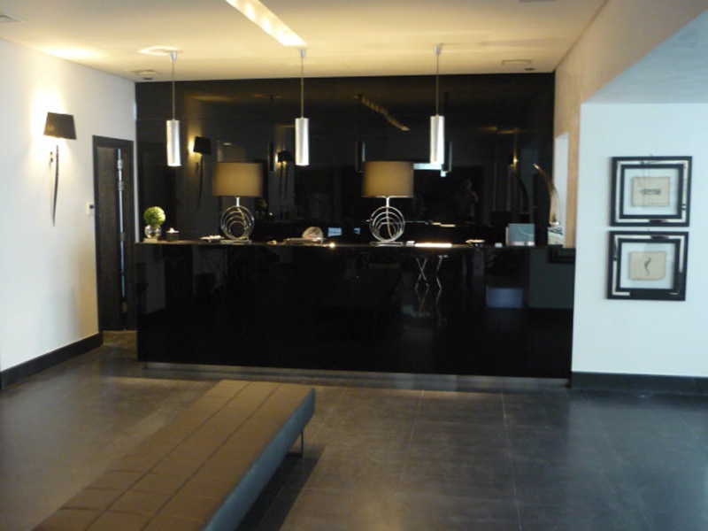 On the walls of the reception of the prestigious HOTEL SANTA MARGHERITA PALACE, you will find our wall lamp with real black ORYX and picture frames in black oak wood inserted with brass nichel plated metal with antic sea subjects prints (seahorse, crab). On the reception desk a pair of table lamps GIRONE in brass nichel plated bases and black shades, a pair of real natural ZEBU horns on squared metal cube, little lighter ISTRICE in black crystal, the GLOBE vase with little clear crystal on squared metal base, brass nichel plated empty pocket with BLACK LEATHER and the one all in metal called MOULE. 