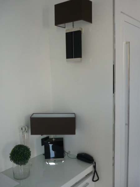 Table lamp ICE in black plexi on metal base, shade black ponge'; wall lamp VENERE in black plexi and metal parts in brass nichel plated, black shade. 