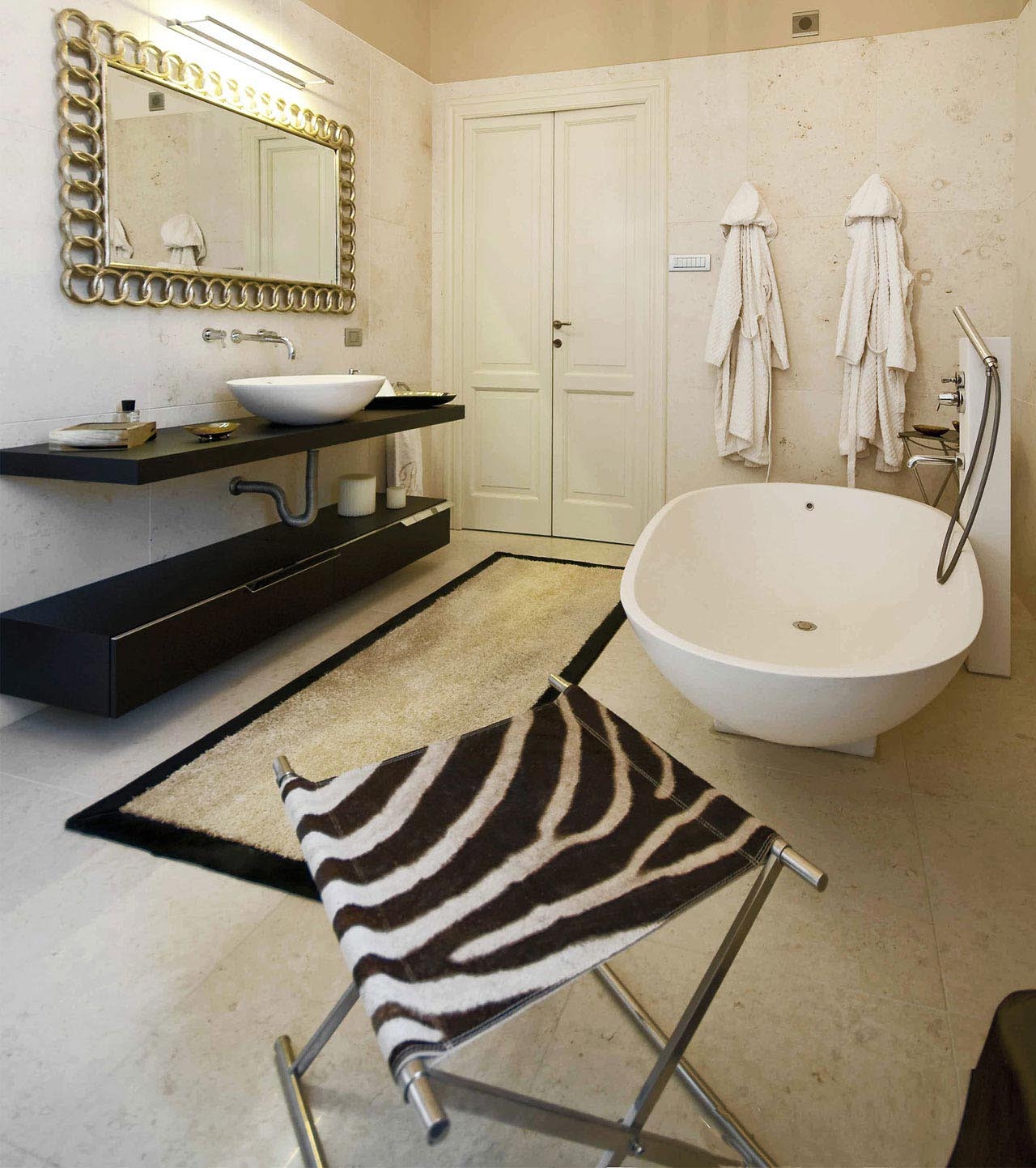 In the master bathroom, our SGABEO with real zebra skin, metal brass nickel finish